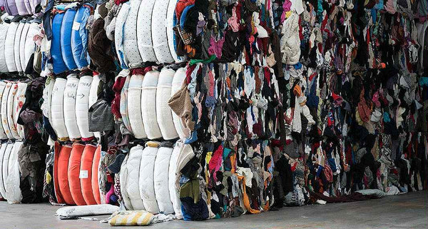 Stacks of colorful fabric rolls in a warehouse setting